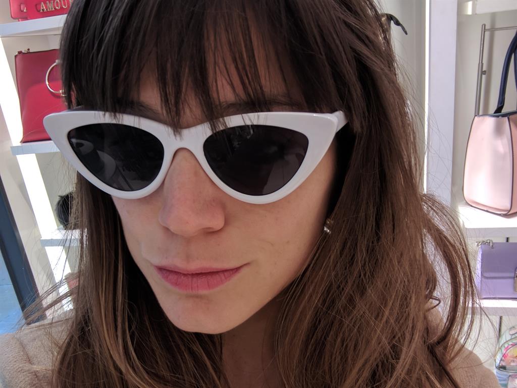 Feline groovy: Amy tries on the cat-eye Meacham sunnies for size