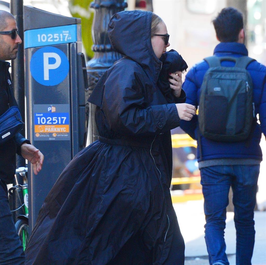 It looks like Adele is pacing pavements to the music ...