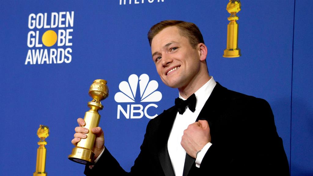 Elt still feels the love: Taron with his gong, after forgetting to credit the Rocketman legend PICTURE: EPA