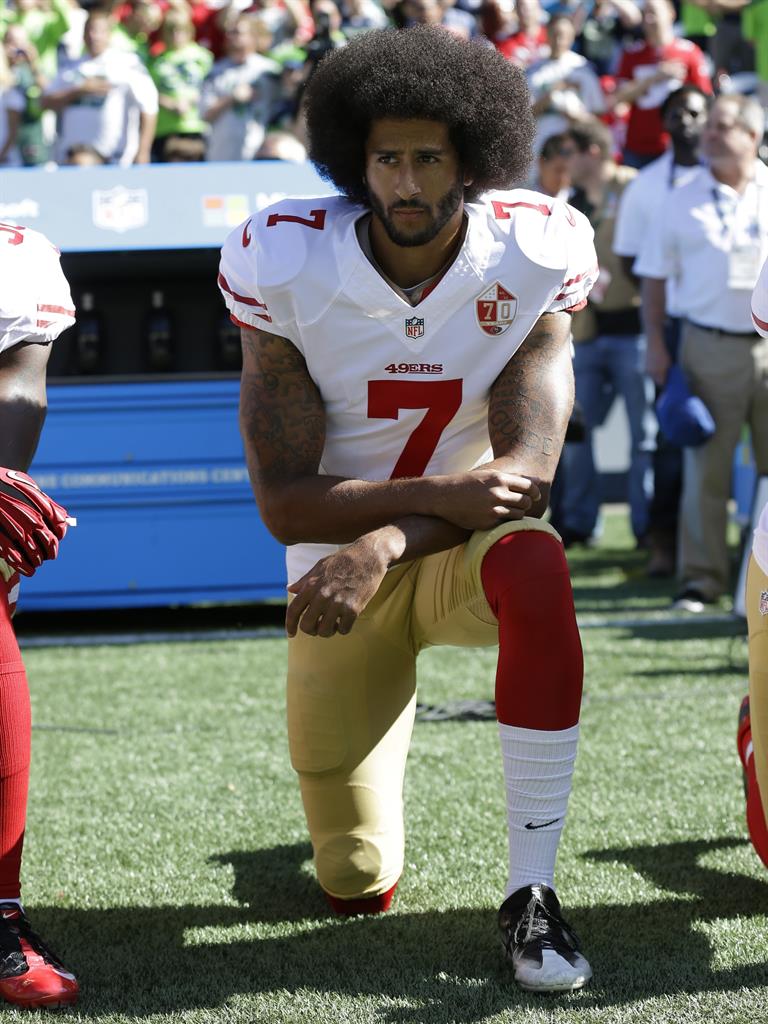 Silent protest: It was US quarterback Colin Kaepernick who popularised the move, not Game Of Thrones' Daenerys Targaryen, below PICTURES: AP