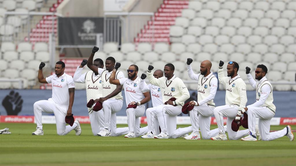 Gesture: West Indies players take a knee before the start of today's play at Old Trafford PICTURES: AP