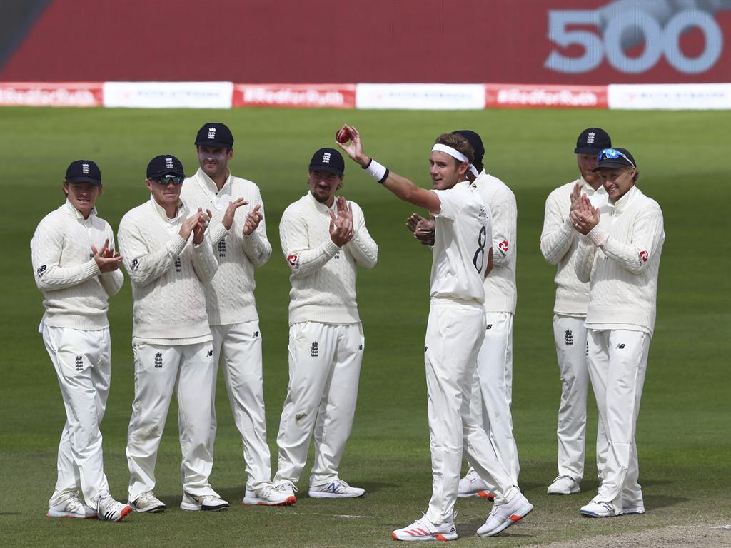 Pace ace: Stuart Broad holds the ball to celebrate taking 500 wickets with his teammates PICTURE: AP