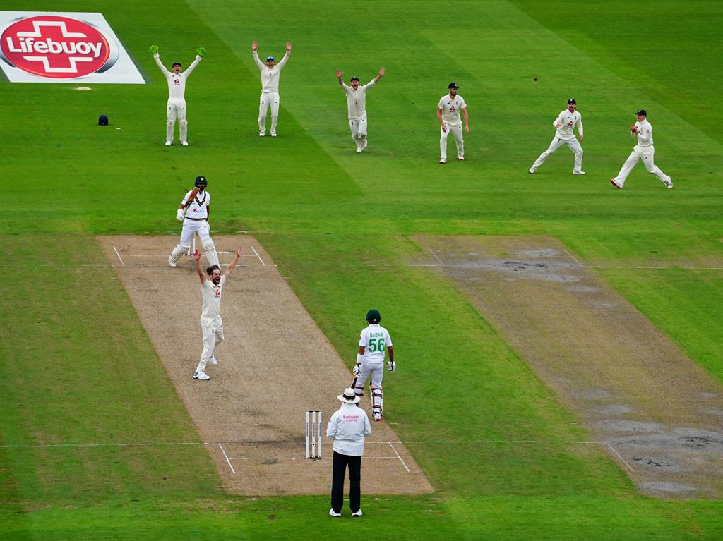 Denied: Chris Woakes of England unsuccessfully appeals for a leg before against Pakistan's Shan Masood PICTURE: REX
