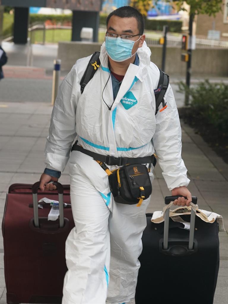 Safety first: A student in protective gear arrives at Newcastle University PICTURE: PA