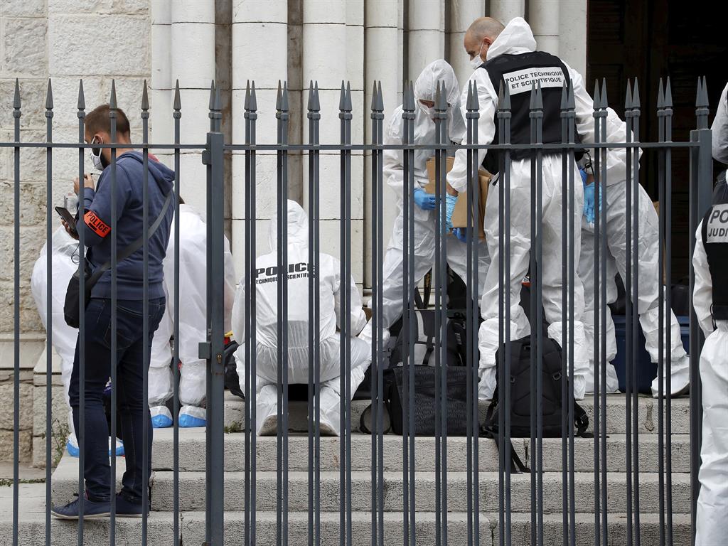 Caricatures: Forensic experts inspect the scene of the knife attack PICTURE: AP