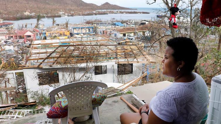 Debris: A woman in Colombia looks out at the havoc caused by Hurricane Iota PICTURE: MAURICIO DUENAS CASTANEDA/EPA